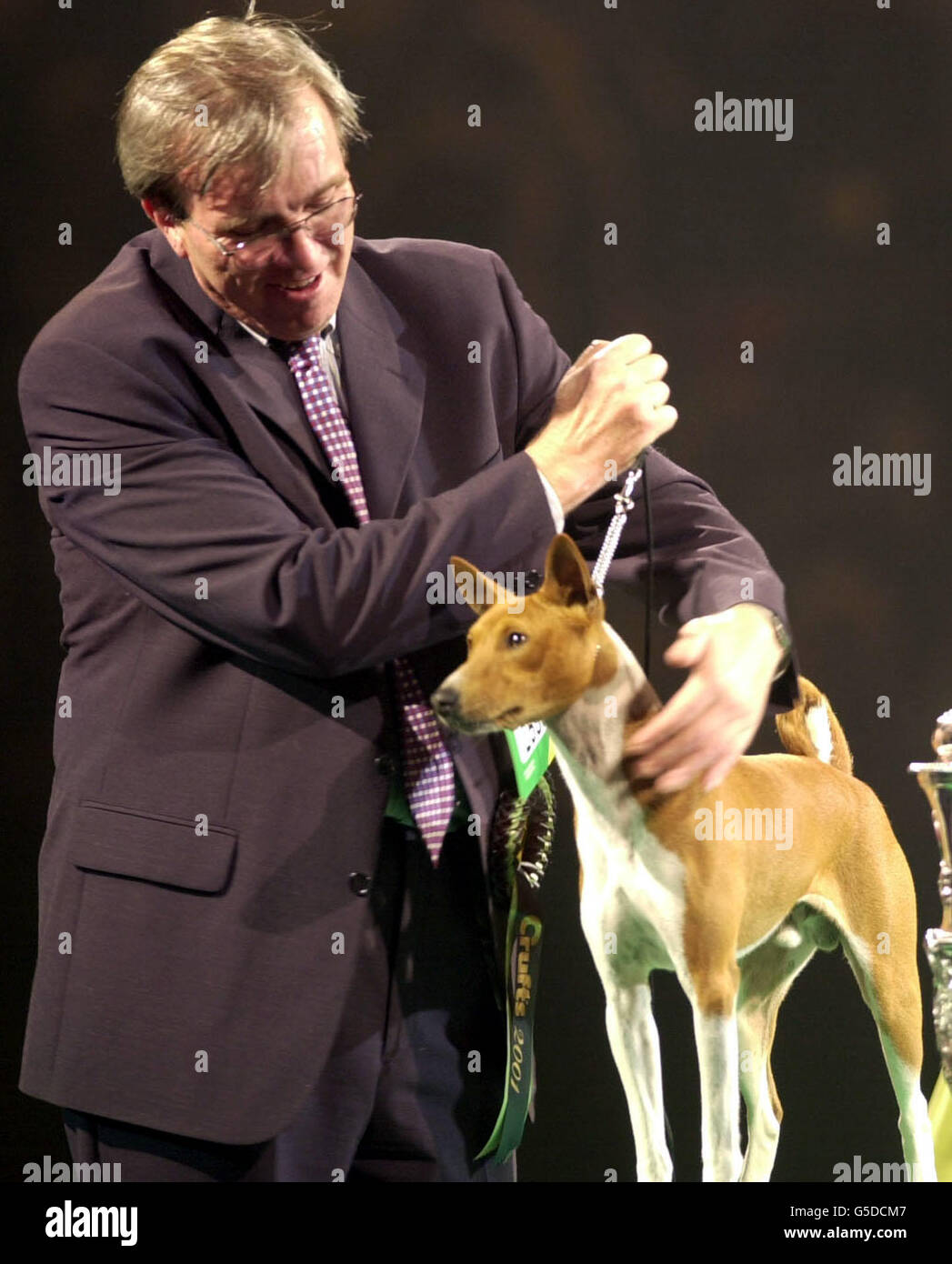 Champion Jethard Cidevant, the Basenji known as Sid, with owner Paul Singleton from Colchester, Essex after being named a Supreme Champion at the Crufts dog show at the Birmingham National Exhibition Centre. Stock Photo
