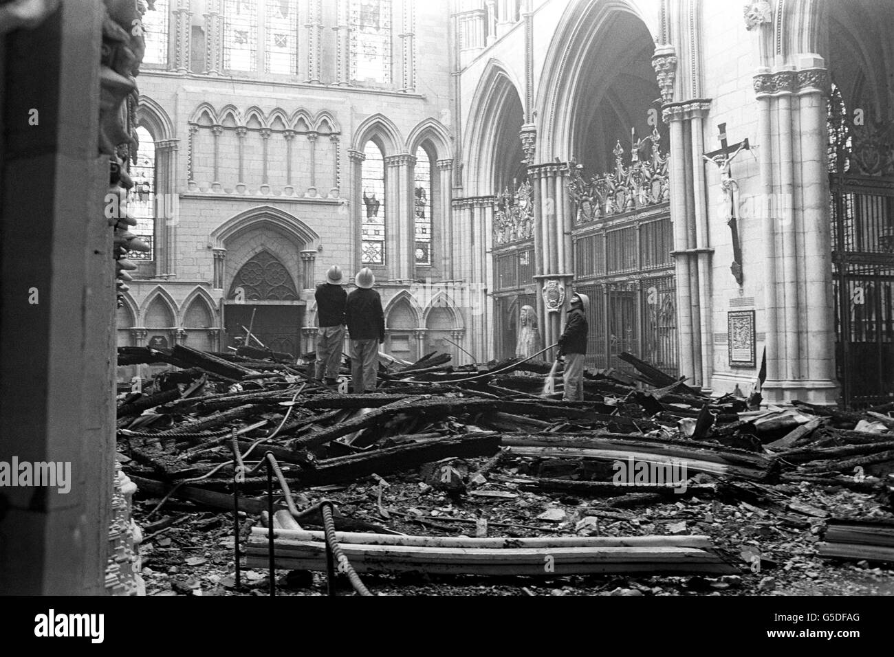Firemen survey the fire damage to the South Transept of York Minster. The South Transept was seriously damaged, but after fighting the blaze for more than three hours firemen saved the rest of the cathedral, including the central tower. *9TH JULY : On this day in 1984 the 13th Century South Transept of York Minster was destroyed by fire. Stock Photo