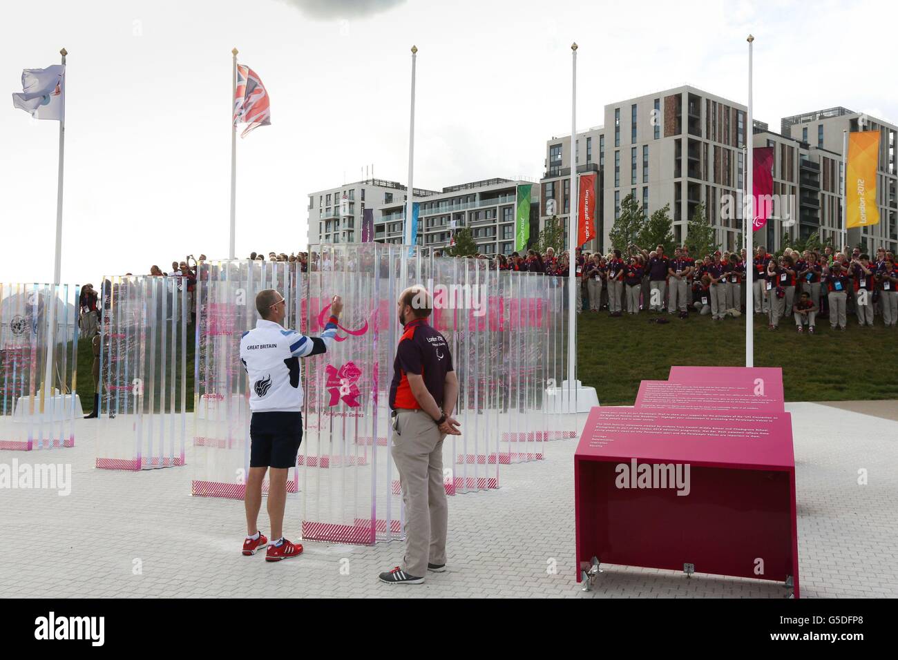 Great Britain's Chef de Mission Craig Hunter signs the peace wall at the Paralympic village, London. Stock Photo