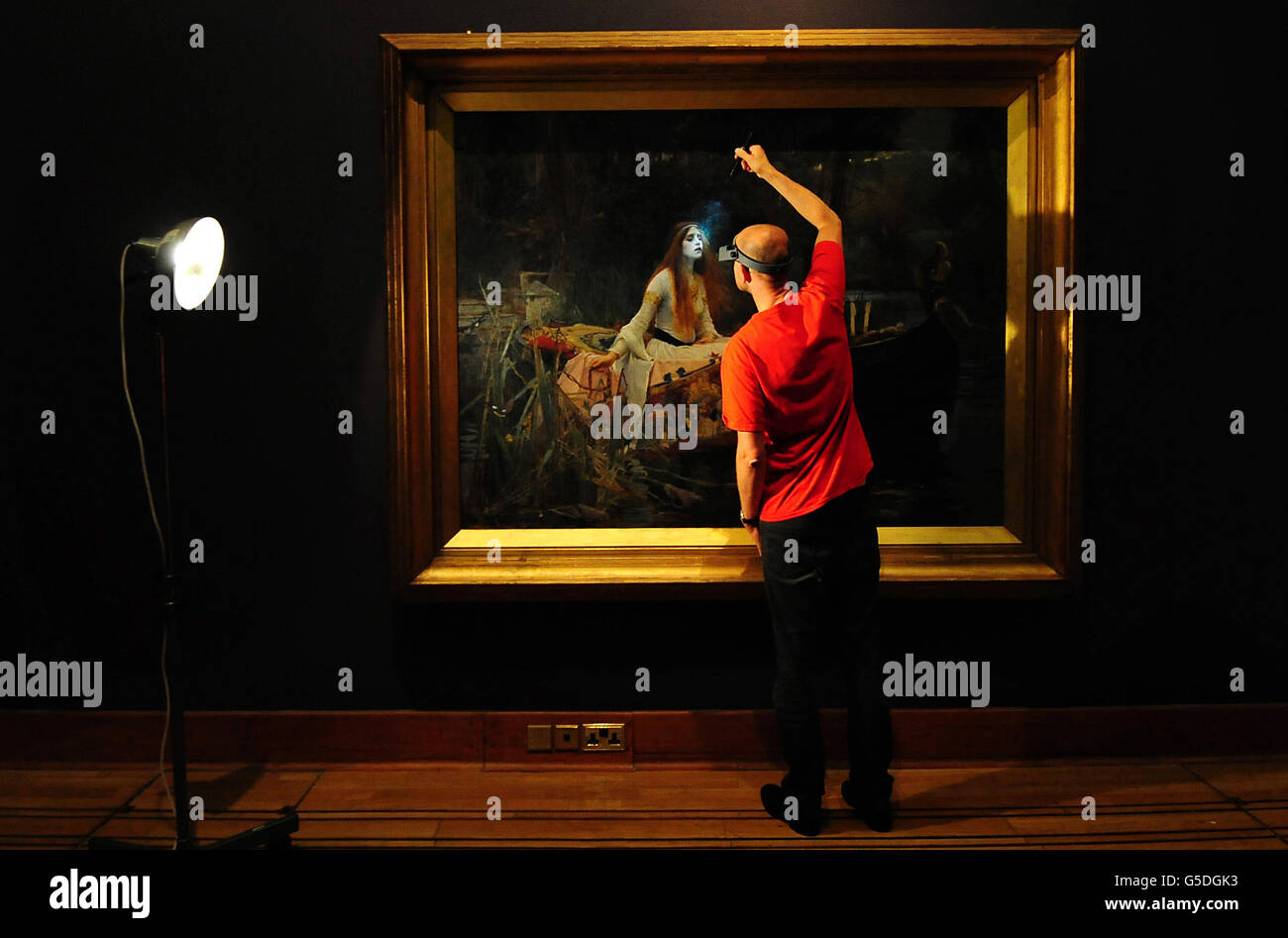 Tate Gallery frame conservation technician Adrian Moore checks John Williams Waterhouse's The Lady of Shalott before an exhibition of Victorian paintings at the Birmingham Museum & Art Gallery, Birmingham. Stock Photo