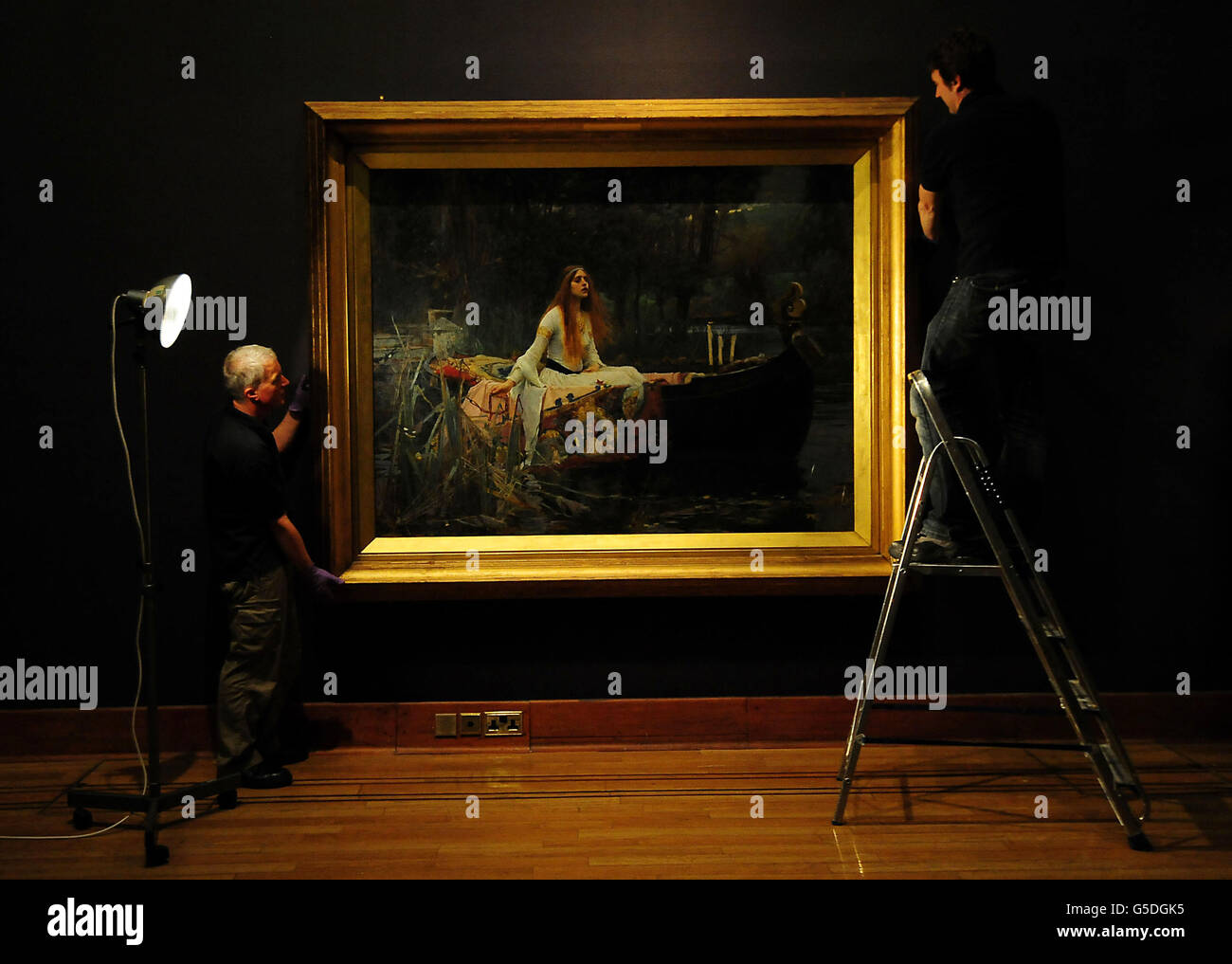 Two Birmingham Museum &amp; Art Gallery workers hang John Williams Waterhouse's The Lady of Shalott before an exhibition of Victorian paintings at the Birmingham Museum &amp; Art Gallery, Birmingham. Stock Photo