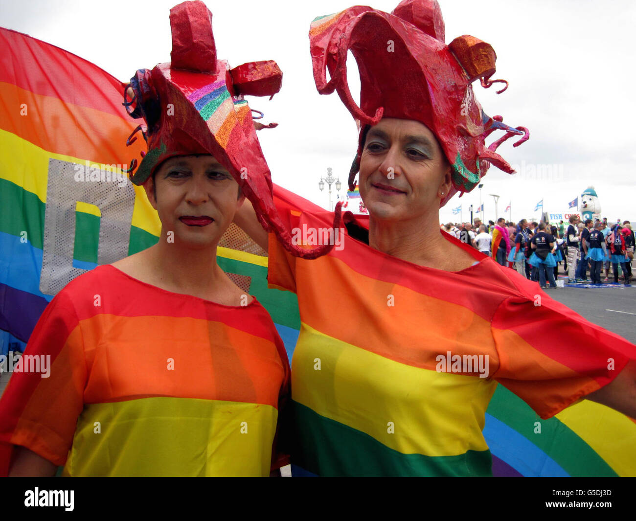 People take part in a parade, part of the Brighton Pride festival in Brighton, as the seaside city marked the 20th anniversary of its Pride celebrations today in typically flamboyant fashion as tens of thousands of people brought colour, noise and eccentricity to its streets. Stock Photo