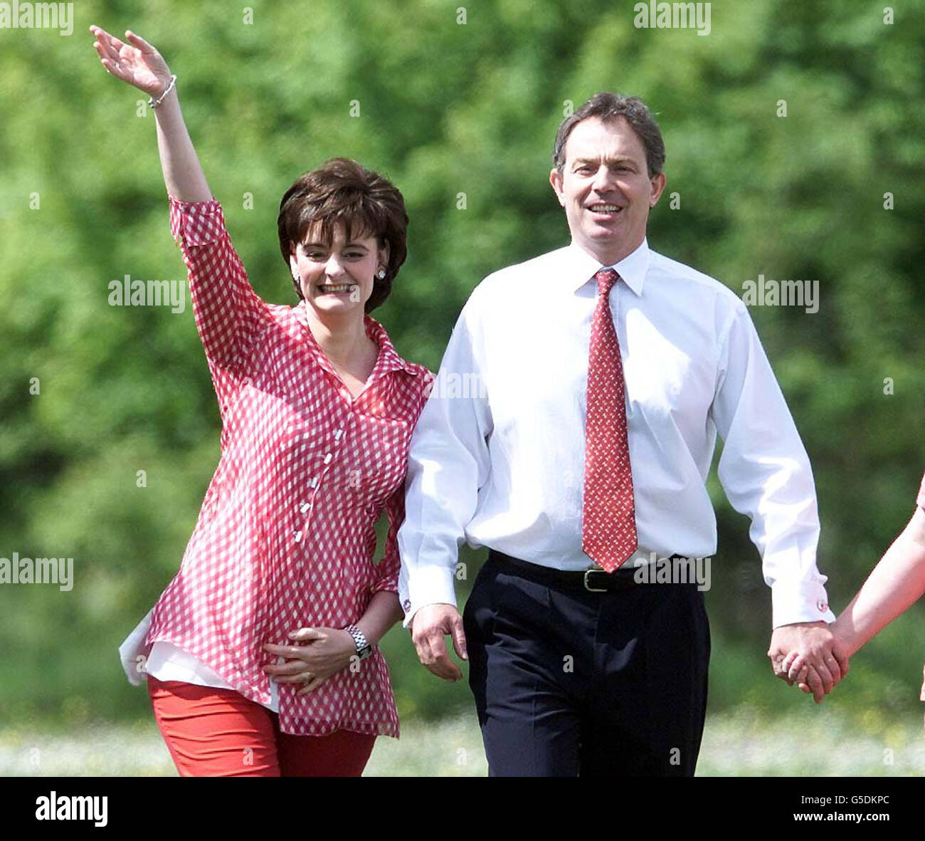 Prime Minister Tony Blair arrives with his wife Cherie to vote in the