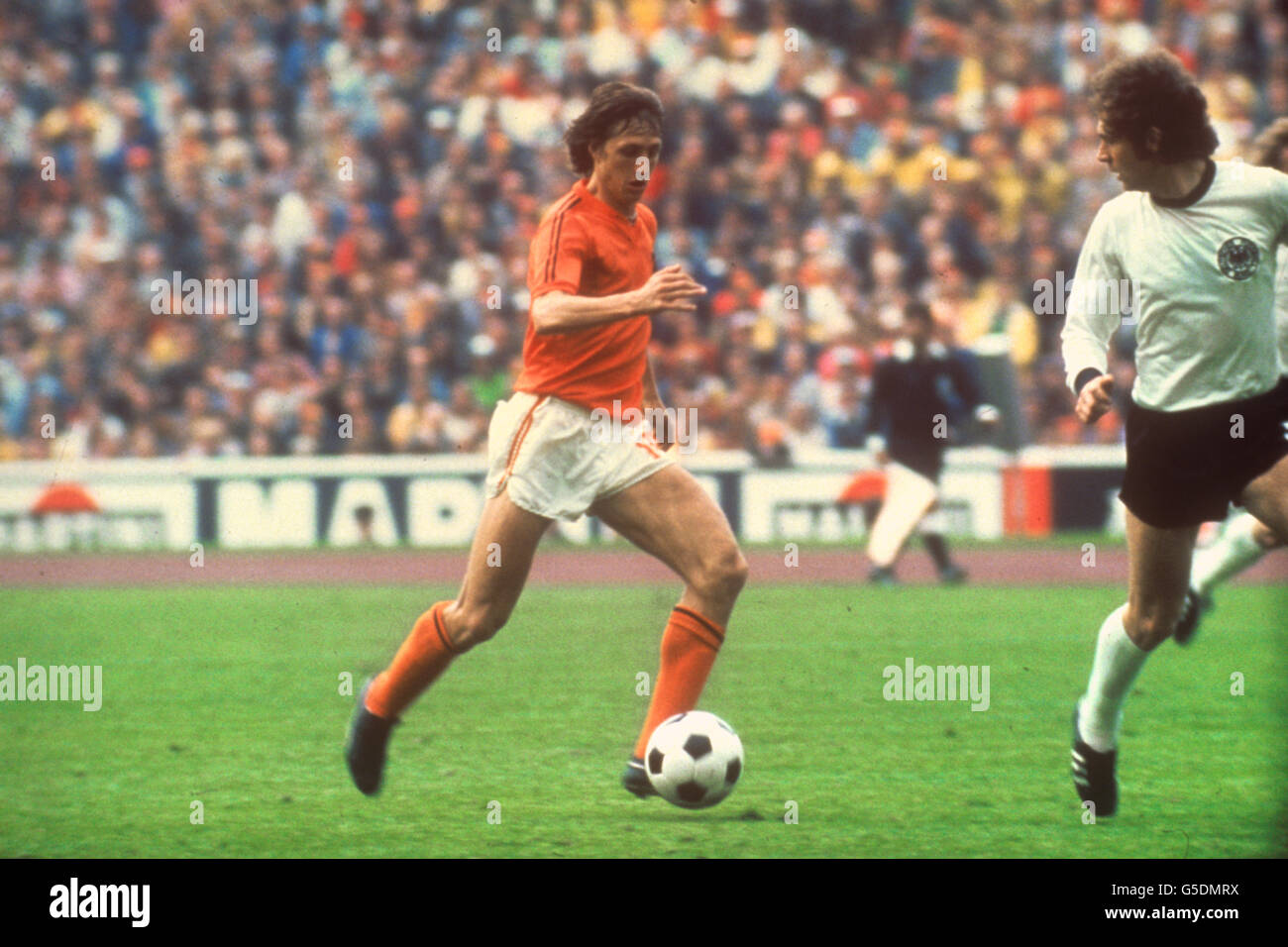 (l-r) Netherlands captain Johan Cruyff tries to get past West Germany captain Franz Beckenbauer. Stock Photo