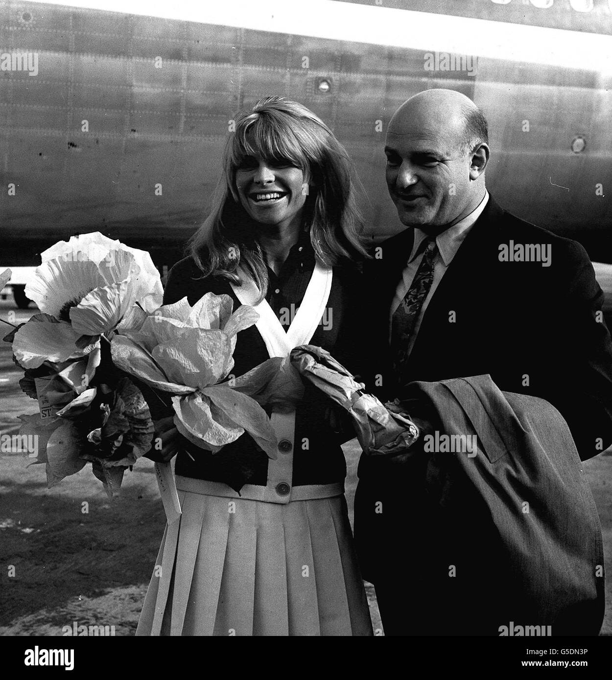 Actress Julie Christie and Film Director John Schlesinger at London Airport. CELEBRITY Stock Photo