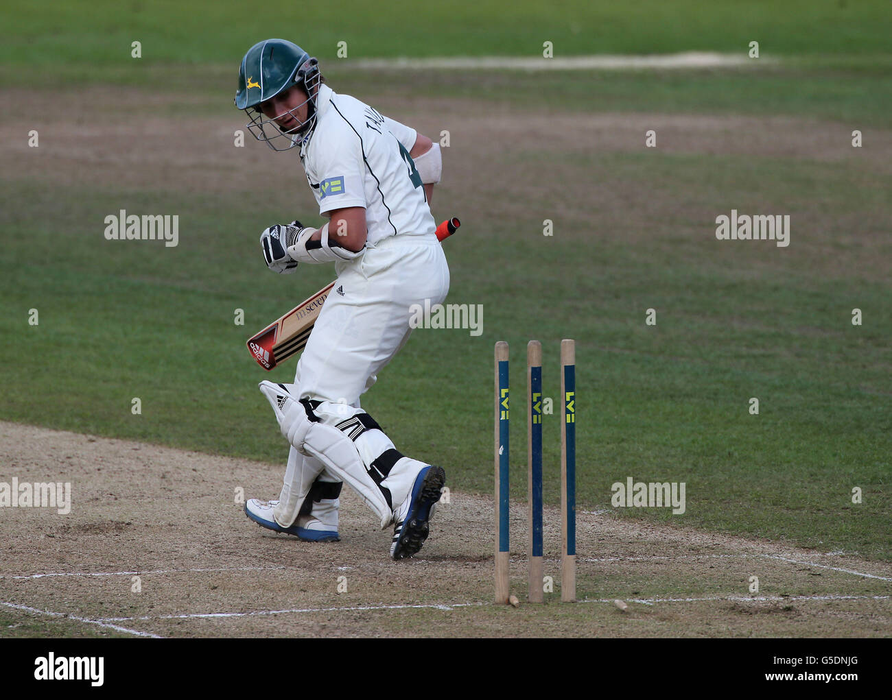 Nottinghamshire batsman James Taylor looks back to find he has stepped on his own wicket during the LV County Championship match at Edgbaston, Birmingham. Stock Photo
