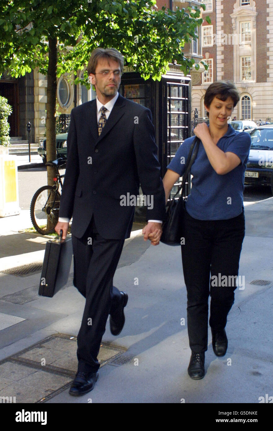 Peter Robson leaves the General Medical Council hearing in central London, with his wife (name unknown), following the hearing where he is accused of touching a woman inappropriately when she went to his surgery to obtain a death certificate. * ... just hours after her grandfather had died. Dr Robson, 36, is also alleged to have behaved inappropriately towards the woman, referred to as Miss B, on two house visits to treat another dying relative. Dr Robson denies all the allegations. Stock Photo