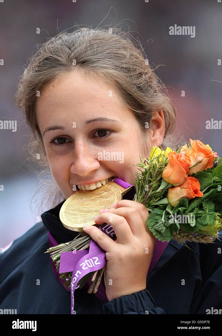 Serbia's Tanja Dragic bites her Gold medal from the Women's Javelin