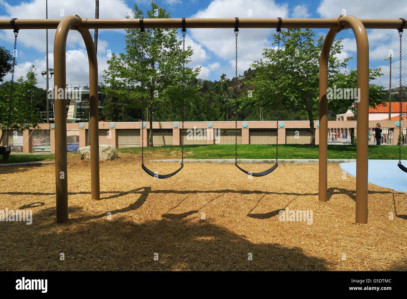 Wanted: children. Empty swing at the playground Stock Photo