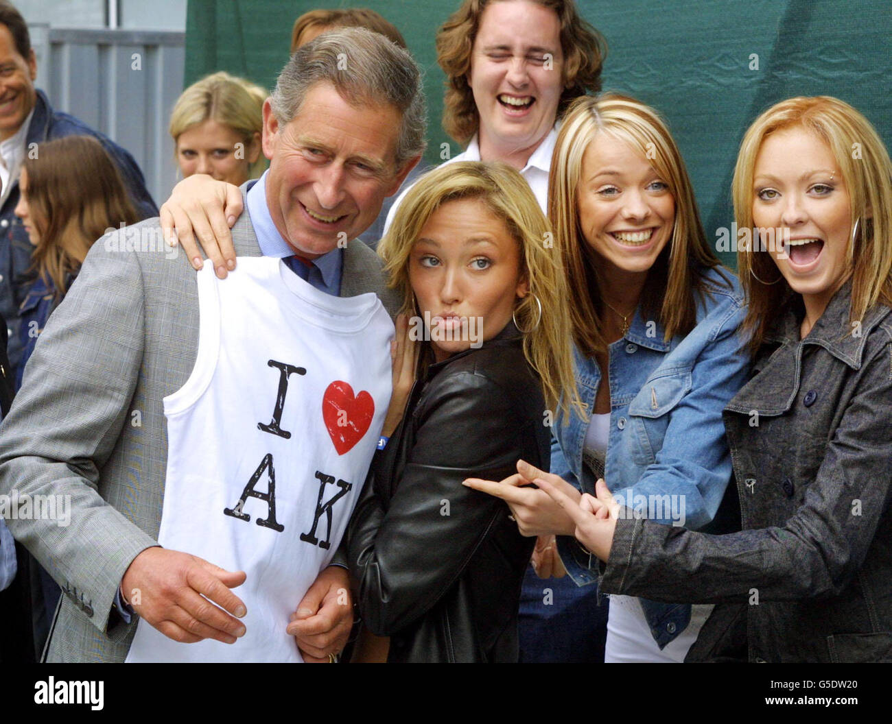 The Prince of Wales is presented with a T-shirt by pop group Atomic Kitten, (LEFT-RIGHT) Jenny Frost, Liz Maclarnon and Natasha Hamilton in London. Atomic Kitten, Prince's Trust ambassadors, played at Party in The Park. *The concert in Hyde Park which 100,000 people to the central London park. Among the acts were Tom Jones, Geri Halliwell and David Gray who played to celebrate 25 years of The Prince's Trust. Stock Photo