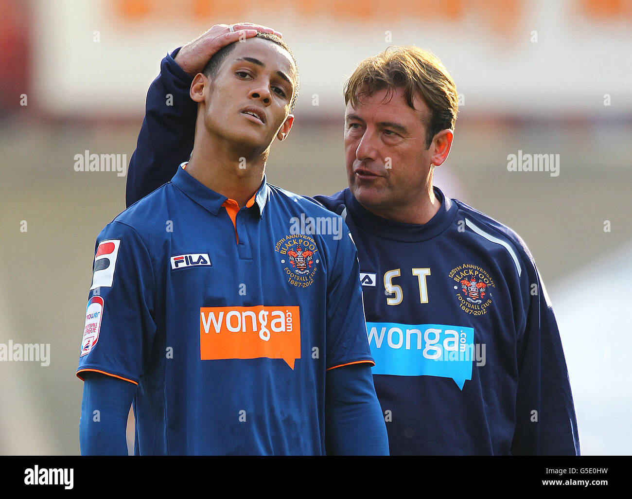 Blackpool's goal scorer Tom Ince is consoled by assistant manager Steve Thompson after the npower Football League Championship match at the Oakwell Stadium, Barnsley. Stock Photo