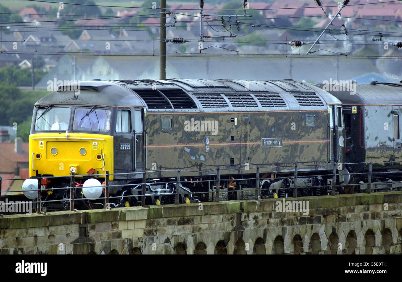 Prince Henry, a Royal Class 47 locomotive, pulls the Royal Train across a viaduct at Berwick-upon-Tweed during a visit by the Queen and Duke of Edinburgh to north east England. The train consists of carriages drawn from a total of eight purpose-built saloons. Stock Photo