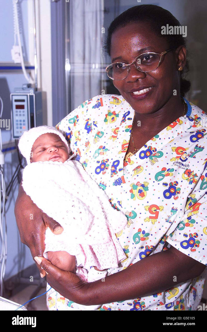 Nurse Beatrice Narh-Saam cradles the baby girl, named Osie by nurses, who was found abandoned in a stairwell just hours after she was born, at the Queen Elizabeth Hospital, Woolwich. The baby was found last night in a block of flats in Burrage Road, south-east London. * ... by a resident and taken to the hospital by police. Nurses named her Osie after Osie Okonkwo, the registrar on duty at the time. The name means good news in a Nigerian tribal language. Police have urged the baby's mother to come forward. Stock Photo