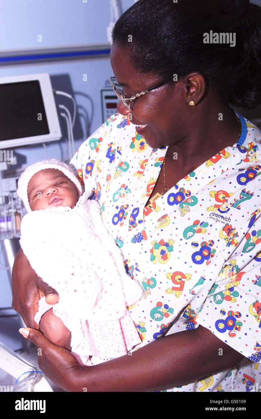 Nurse Beatrice Narh-Saam cradles the baby girl, named Osie by nurses, who was found abandoned in a stairwell just hours after she was born, at the Queen Elizabeth Hospital, Woolwich. The baby was found last night in a block of flats in Burrage Road, south-east London. * ... by a resident and taken to the hospital by police. Nurses named her Osie after Osie Okonkwo, the registrar on duty at the time. The name means good news in a Nigerian tribal language. Police have urged the baby's mother to come forward. Stock Photo