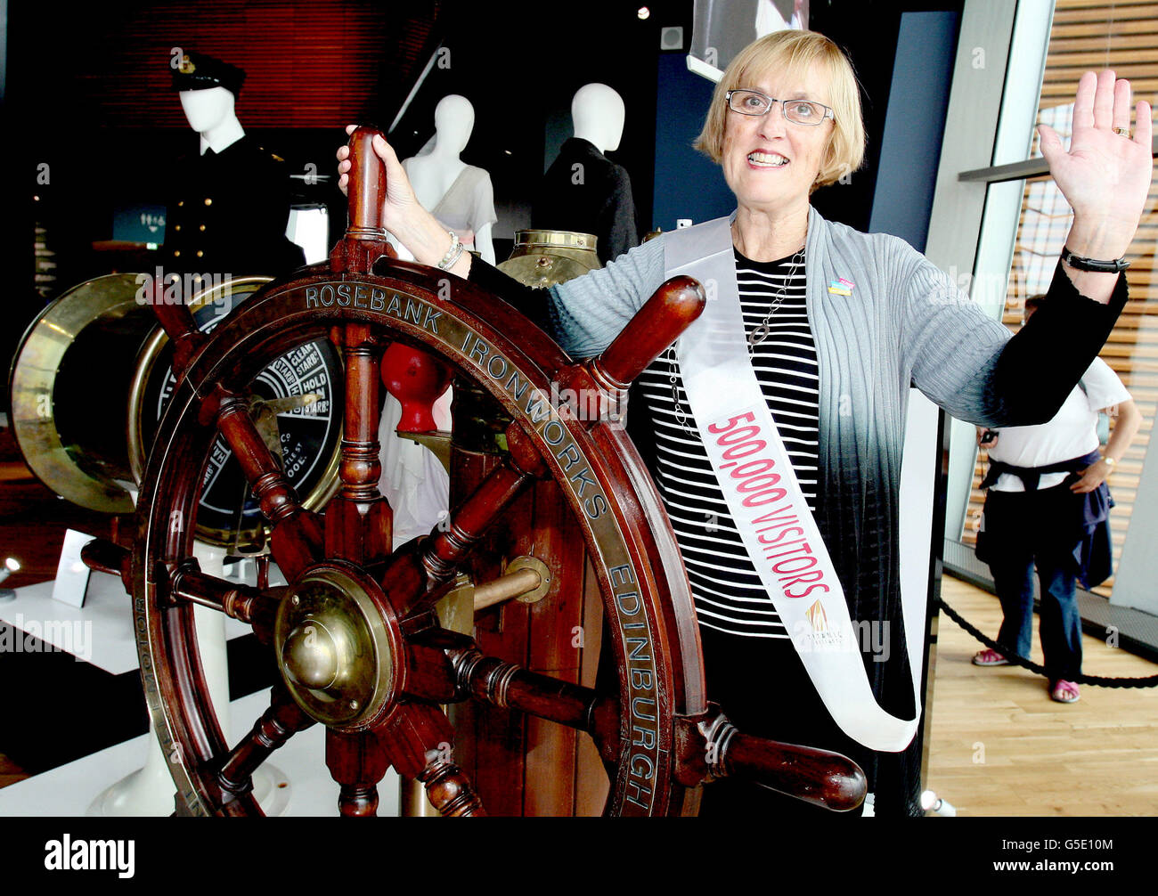 Canadian Lynda Price celebrates beside the wheel from the movie Titanic