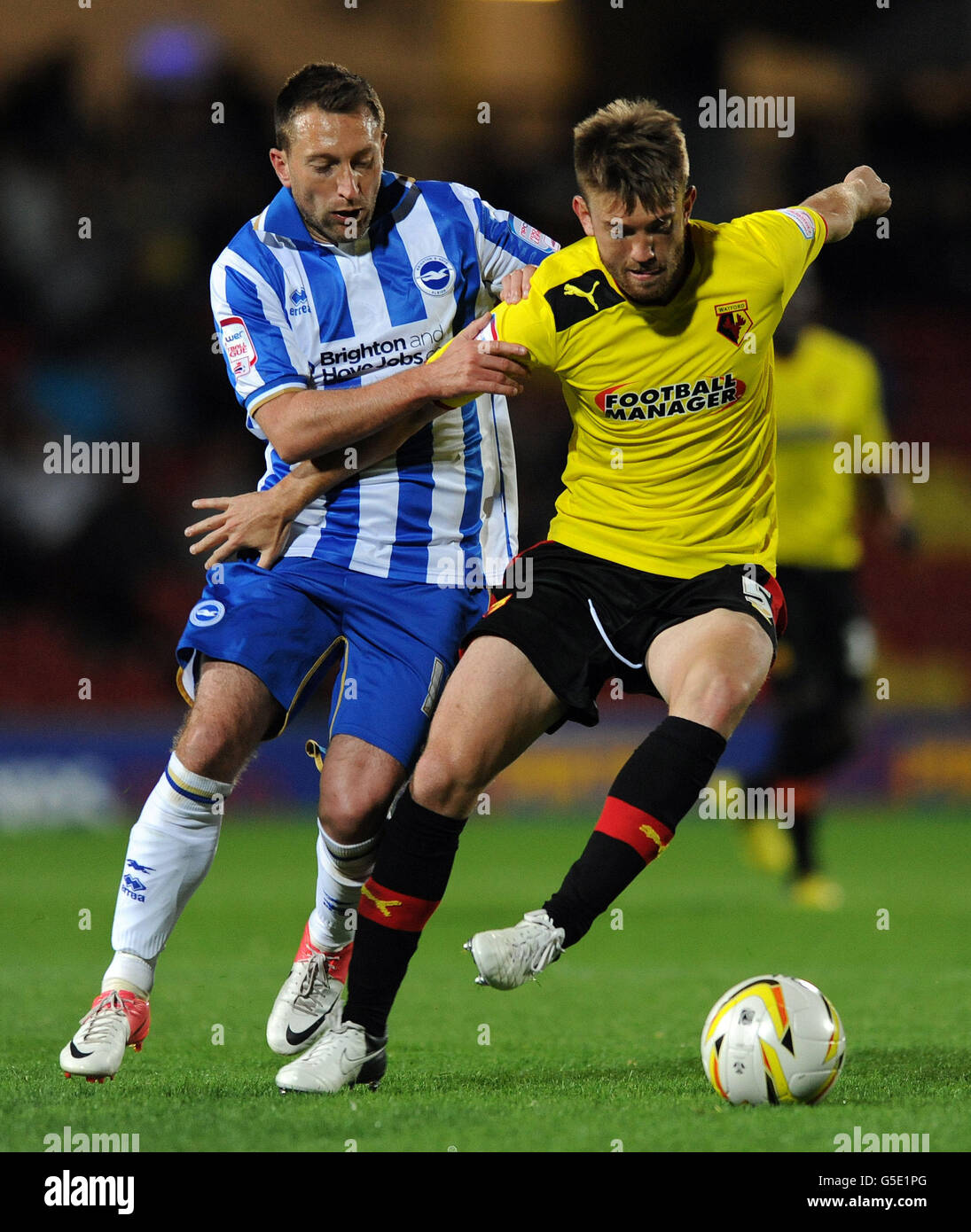 Brighton & Hove Albion's Stephen Dobbie (left) and Watford's Piccoli Neuton battle for the ball during the npower Championship match at Vicarage Road, Watford. Stock Photo