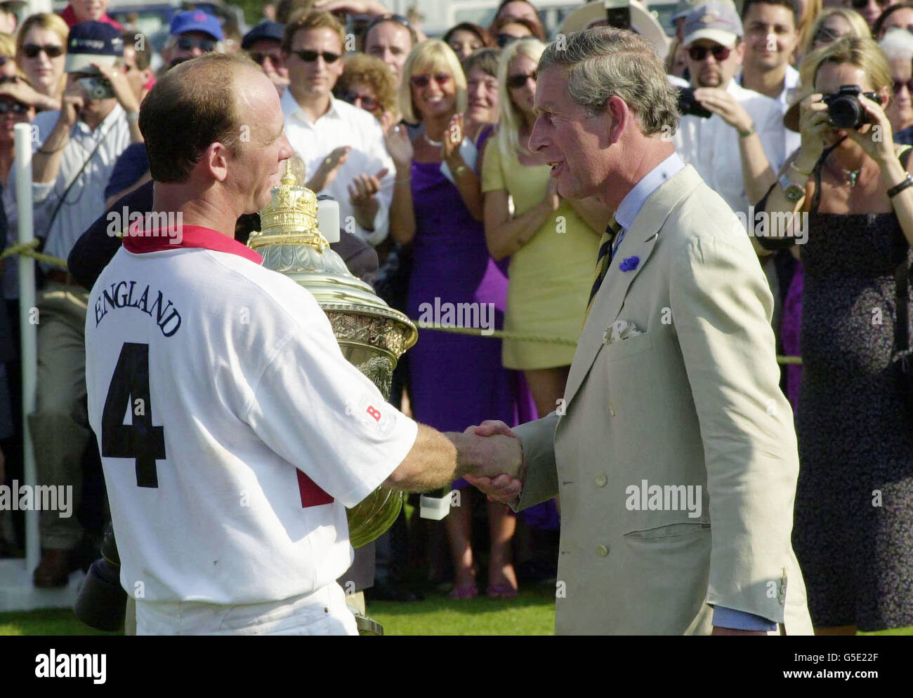 The Prince of Wales, presents the Coronation Cup to England captain Andrew  Hine after they beat Brazil 8-7 at polo at Cowdray Park, Sussex Stock Photo  - Alamy
