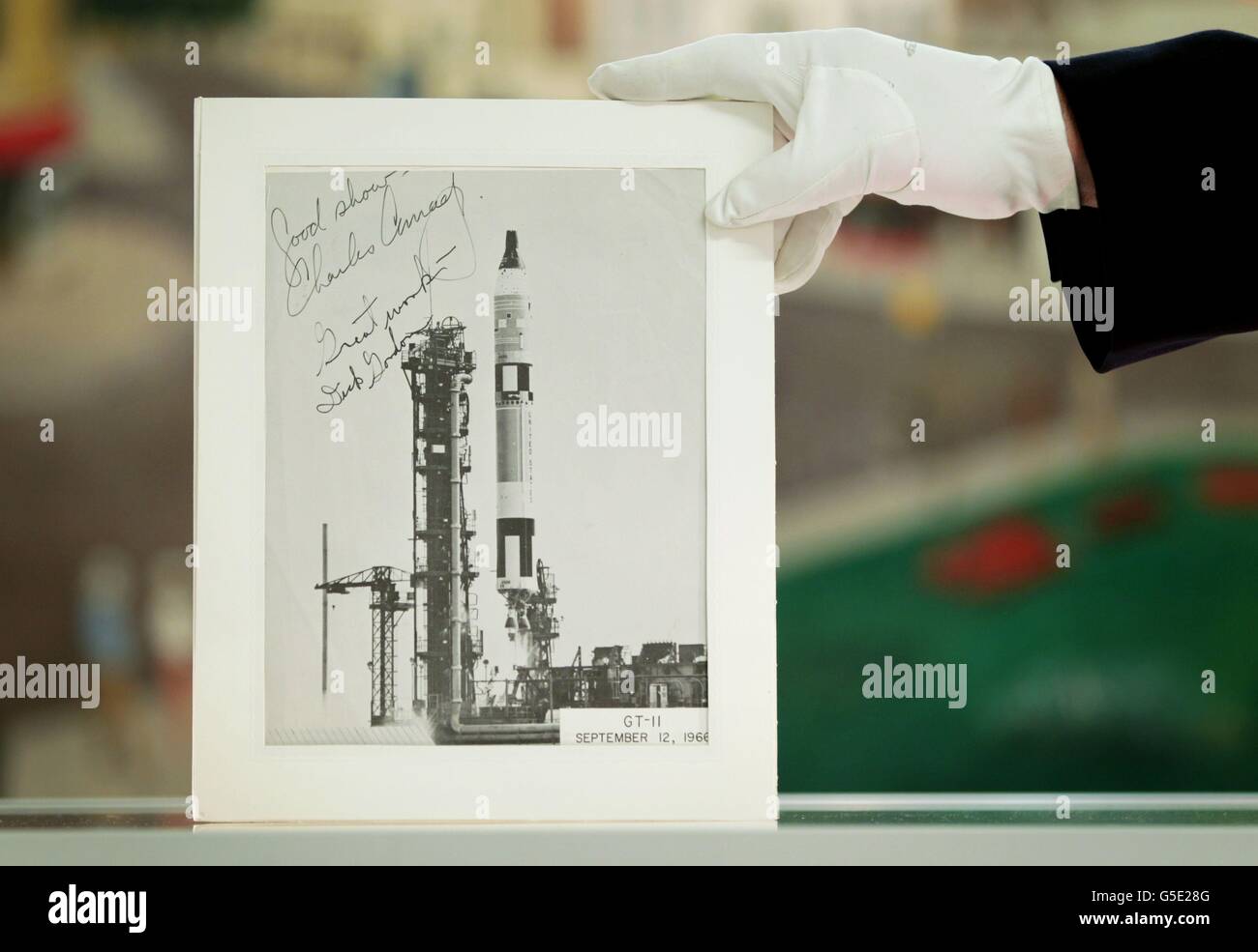 Jonathan Riley of Grand Auctions in Folkestone, Kent, holds a photograph of the Gemini 11 lift-off in 1966, piloted by astronauts Charles 'Pete'' Conrad and Richard Gordon, which is included in an auction of space memorabilia that was collected by Nasa technician Bob Harvey, who was killed while fuelling a Titan rocket. Stock Photo
