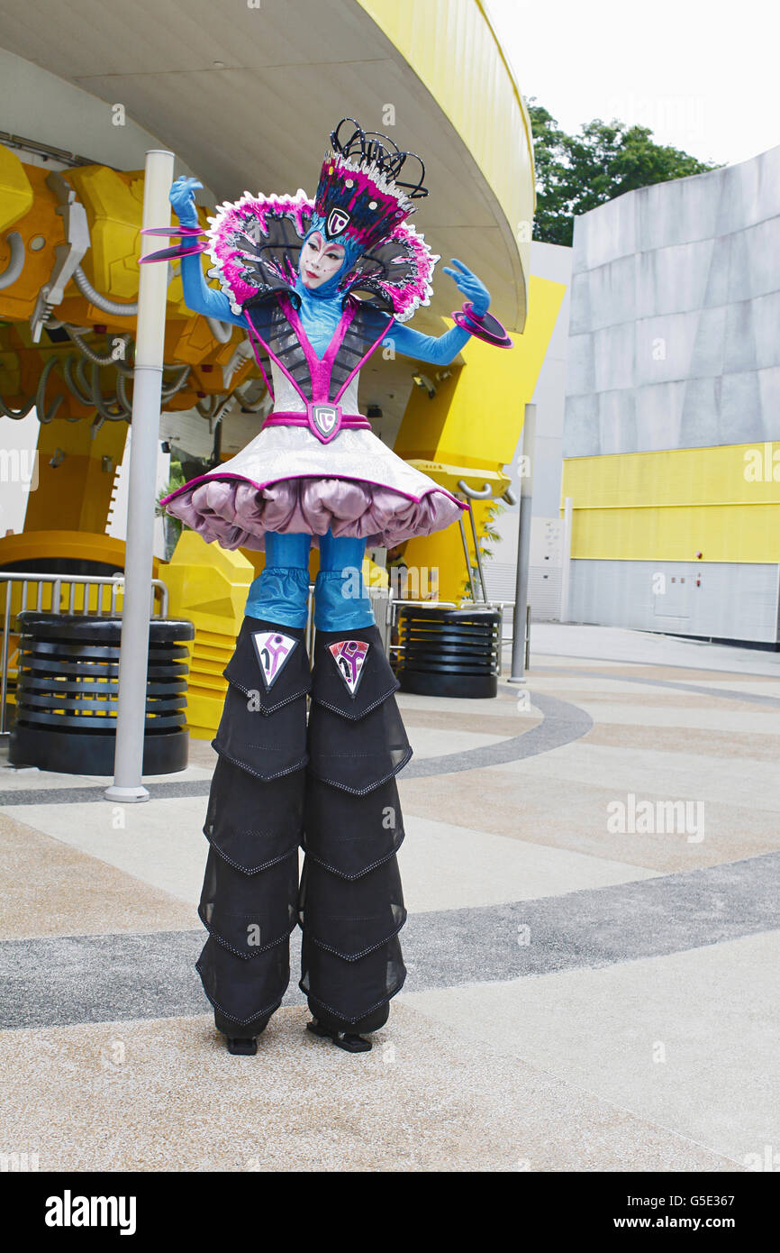 A robo woman wearing colorful outfit and standing on stilts, Universal Studio, Singapore Stock Photo