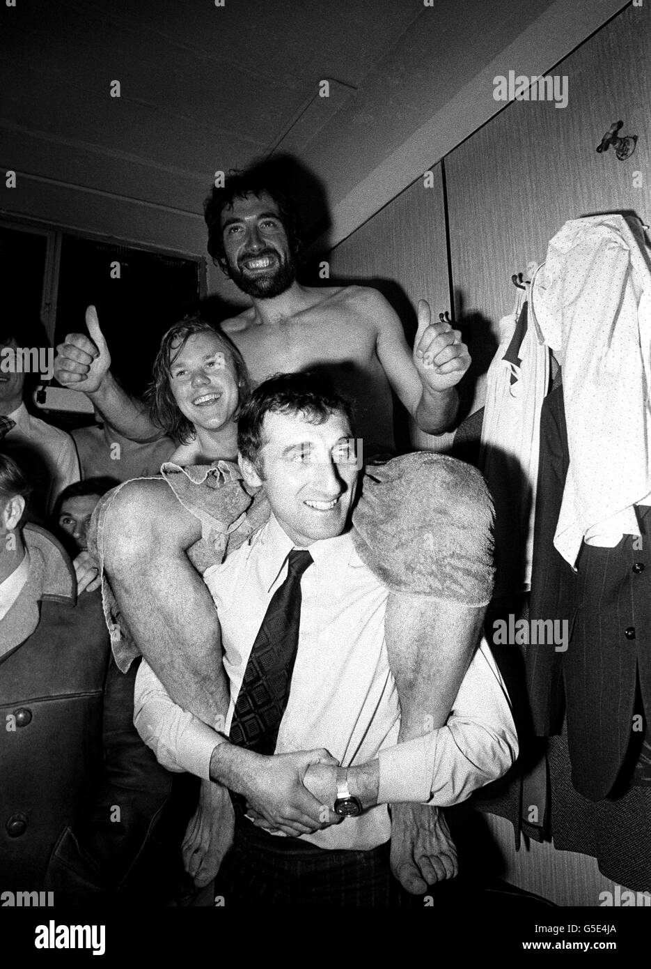 In the dressing room at Leeds United's Elland Road ground after yesterday's Nil-Nil match, bearded Wimbledon hero Dickie Guy on the back of their coach Brian Hall Stock Photo