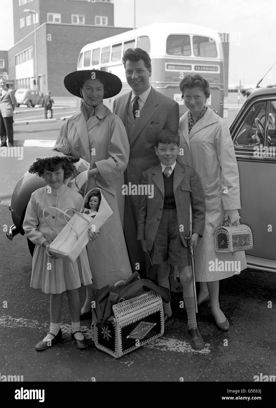 Home from holiday are comedian Max Bygraves, his wife Gladys 'Blossom' Murray and their children Christine (14), Anthony (10) and Maxine (6). The Bygraves had spent three weeks in Spain and France. Stock Photo