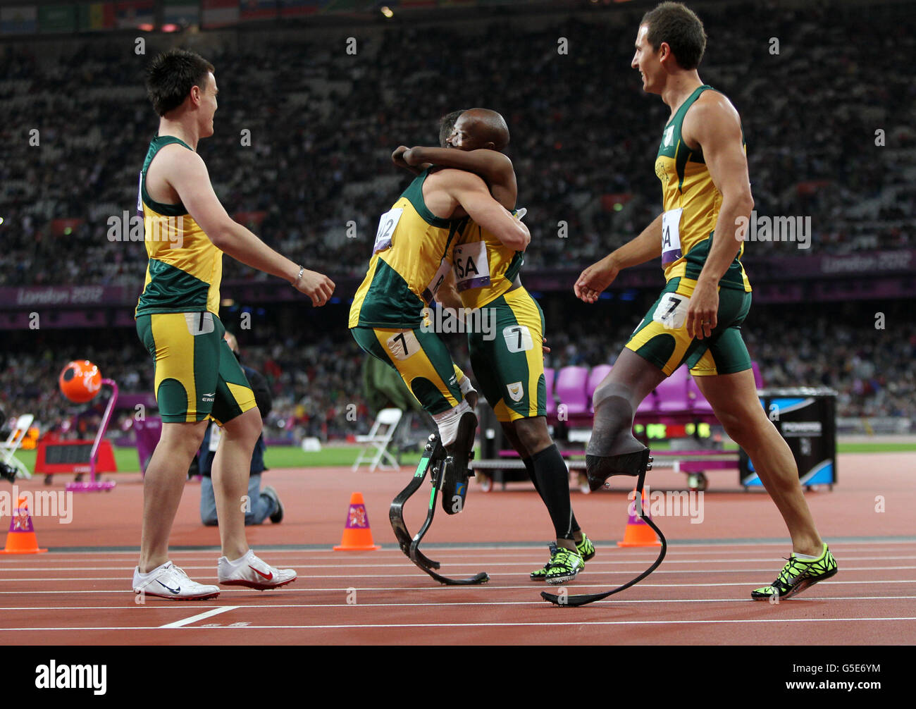 The South Africa team of Oscar Pistorius (centre left) celebrates with Samkelo Radbee (centre right), Zivan Smith and Arnu Foure after winning Gold in a world record time during the Men's 4x100m - T42-T46 Final at the Olympic Stadium, London. Stock Photo