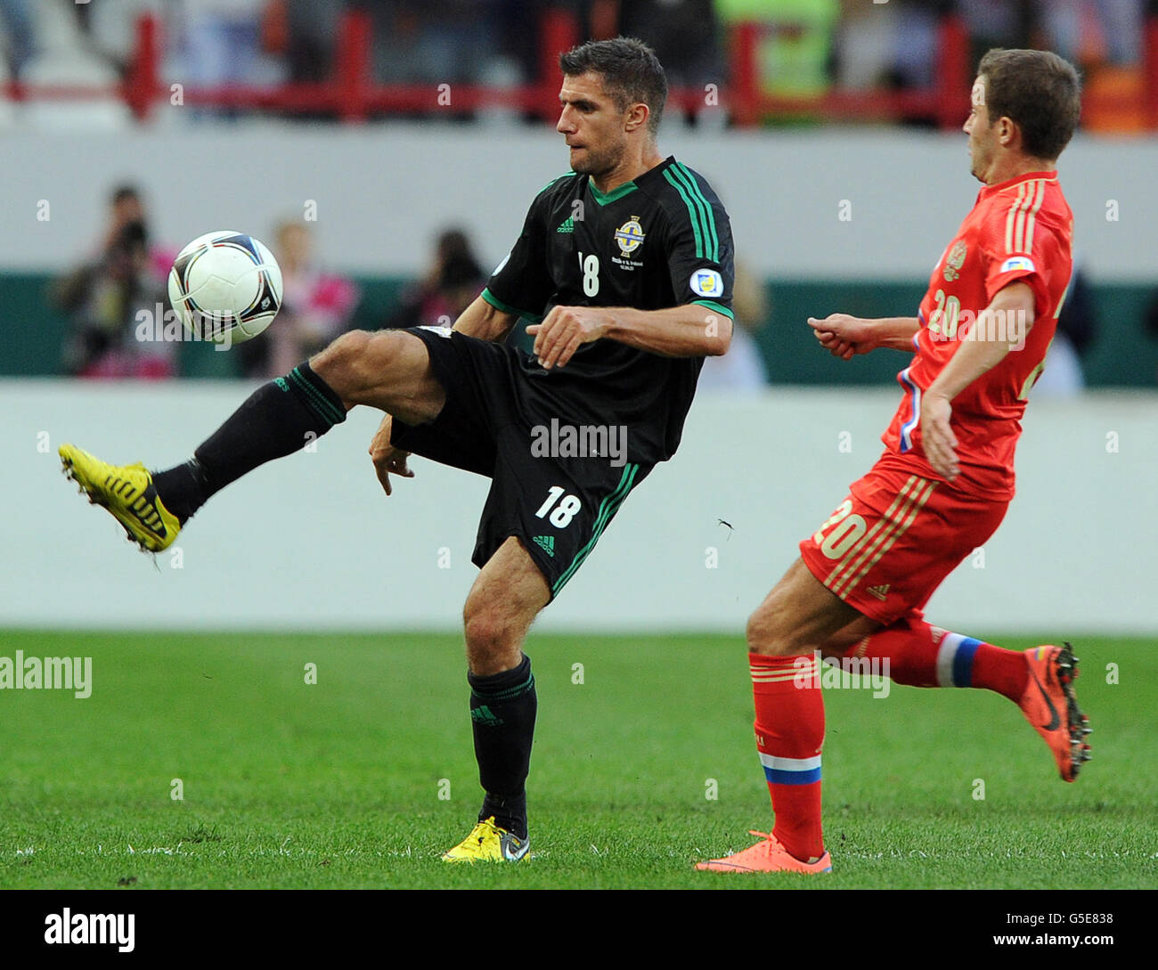 Russia's Viktor Fayzulin and Northern Ireland's Aaron Hughes battle for the ball during the 2014 FIFA World Cup Group F qualifier between Russia and Northern Ireland at Lokomotiv Stadium. Stock Photo
