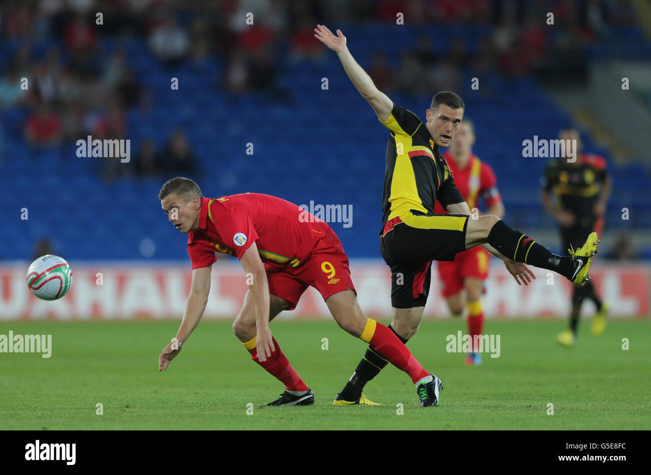 Wales' Steve Morison challenges Begium defender Jan Vertonghen (right) during the 2014 Fifa World Cup Qualifying match at the Cardiff City Stadium, Cardiff. Stock Photo