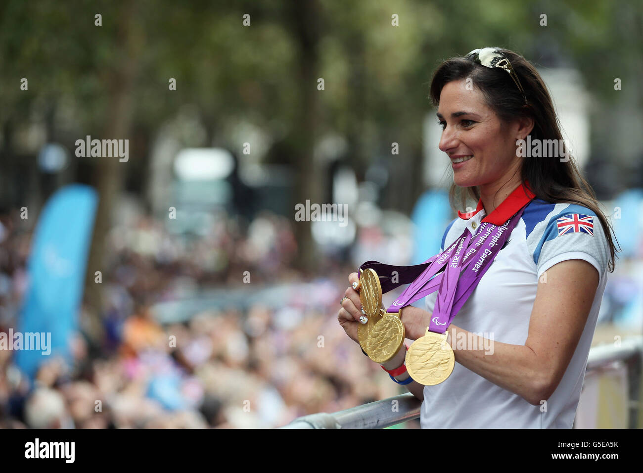 British Paralympic gold medal winning cyclist Sarah Storey shows her medals to the crowd during