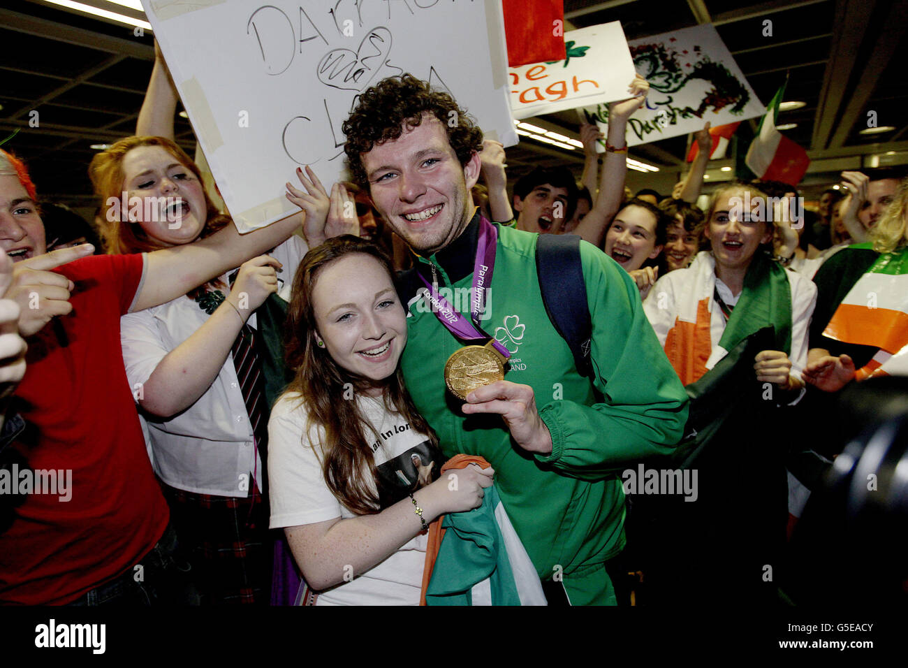 Irish Athlete and gold medal winner Darragh McDonald arrives back into Dublin Airport with his girlfriend Clara Peters after the London 2012 Paralympic Games to a massive welcome after the team's fantastic medal haul at the games. Stock Photo