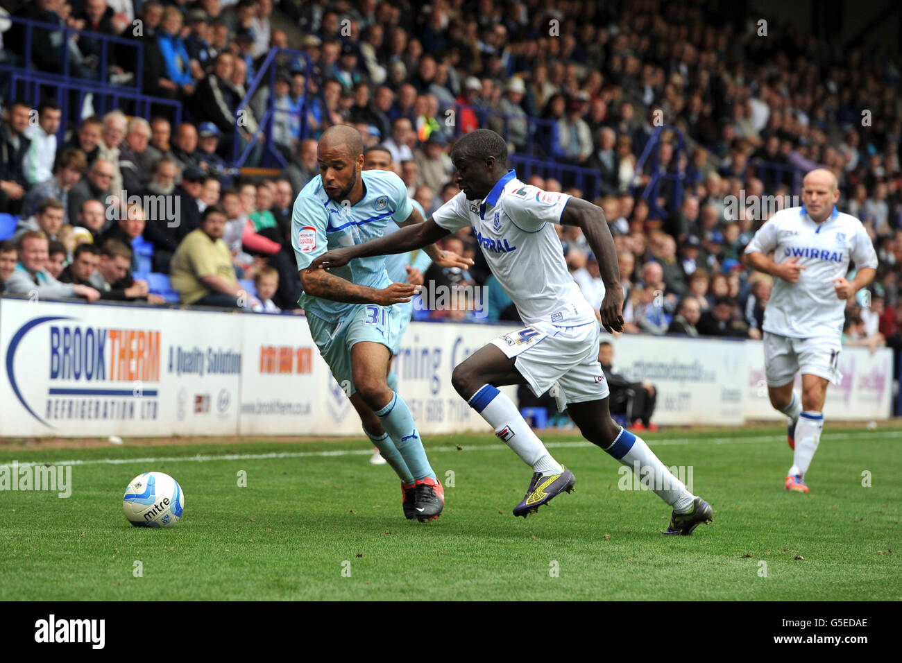 Coventry City's David McGoldrick (left) and Tranmere Rovers' Zoumana Bakayogo battle for the ball. Stock Photo
