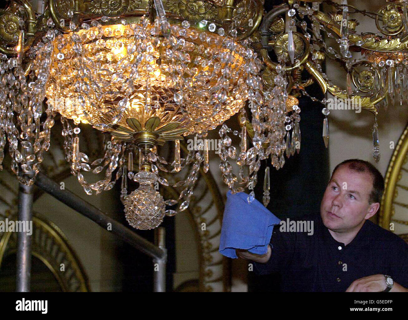 Technician Mark Boyd cleans the largest chandelier in the Music Room