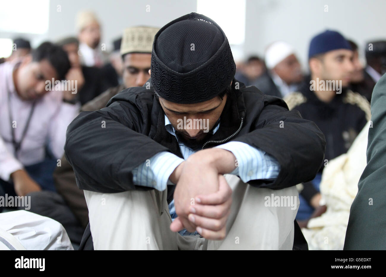 Muslims congregate at the Baitul Futuh Mosque in Morden, to listen to the Islamic Khalifa's sermon and to denounce the anti-Islamic film entitled 'Innocence of Islam'', the community also denounced the violent reaction to the film. Stock Photo