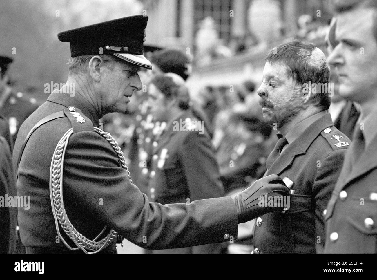The Duke of Edinburgh, as Senior Colonel of the Household Division, pins the South Atlantic Medal on Guardsman Simon Weston, from Gwent, at Buckingham Palace in London. Guardsman Weston was wounded during the attack on the Sir Galahad during the Falklands War. Stock Photo
