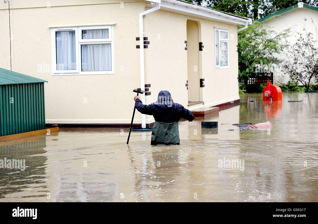 A resident of Knaresborough wades through water following flooding from the River Nidd in the town. Stock Photo
