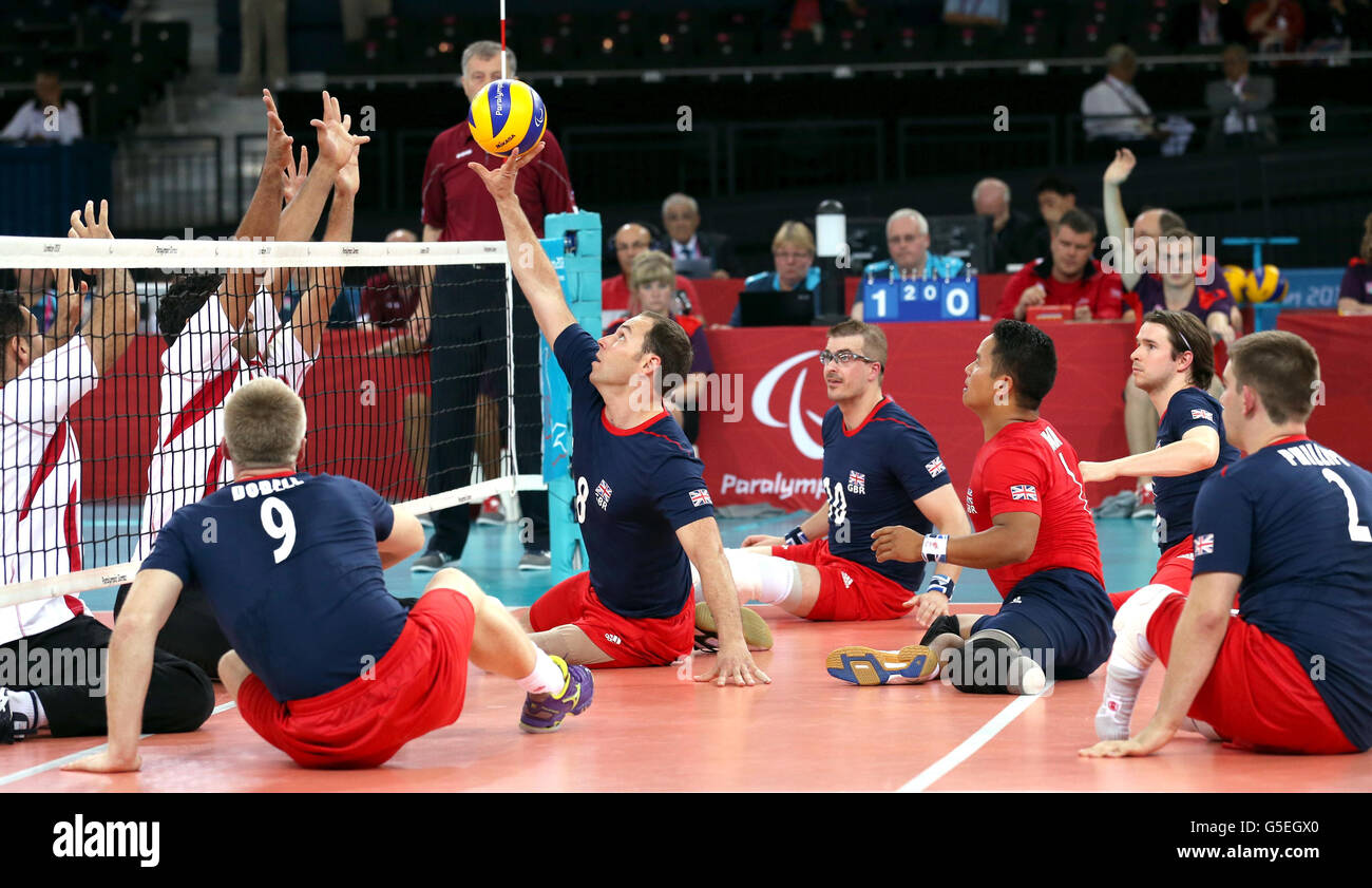 Great Britain's Anton Raimondo plays a shot during the Men's Sitting Volleyball match against Egypt on day two of the London 2012 Paralympic Games at the London ExCel Centre. Stock Photo