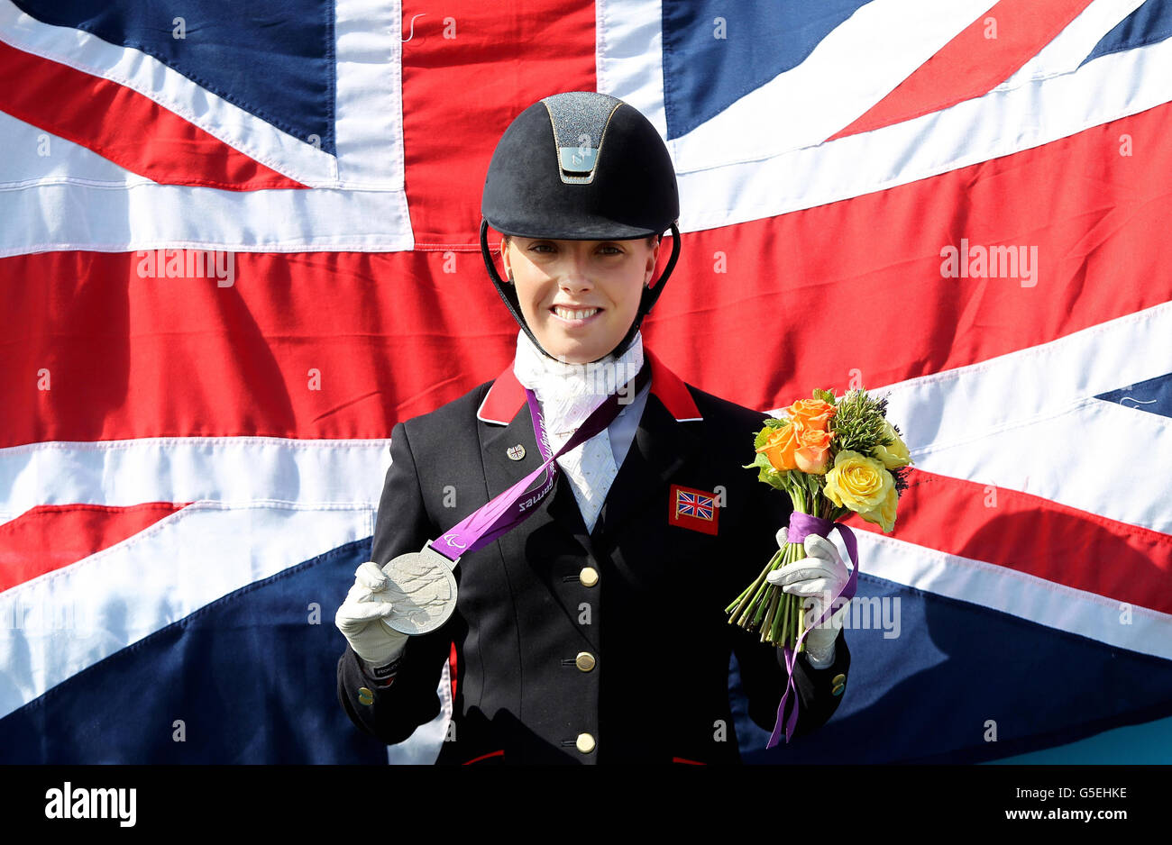 Great Britain's Sophie Wells celebrates her silver medal in the Dressage Individual Freestyle Test Grade IV at Greenwich Park. Stock Photo