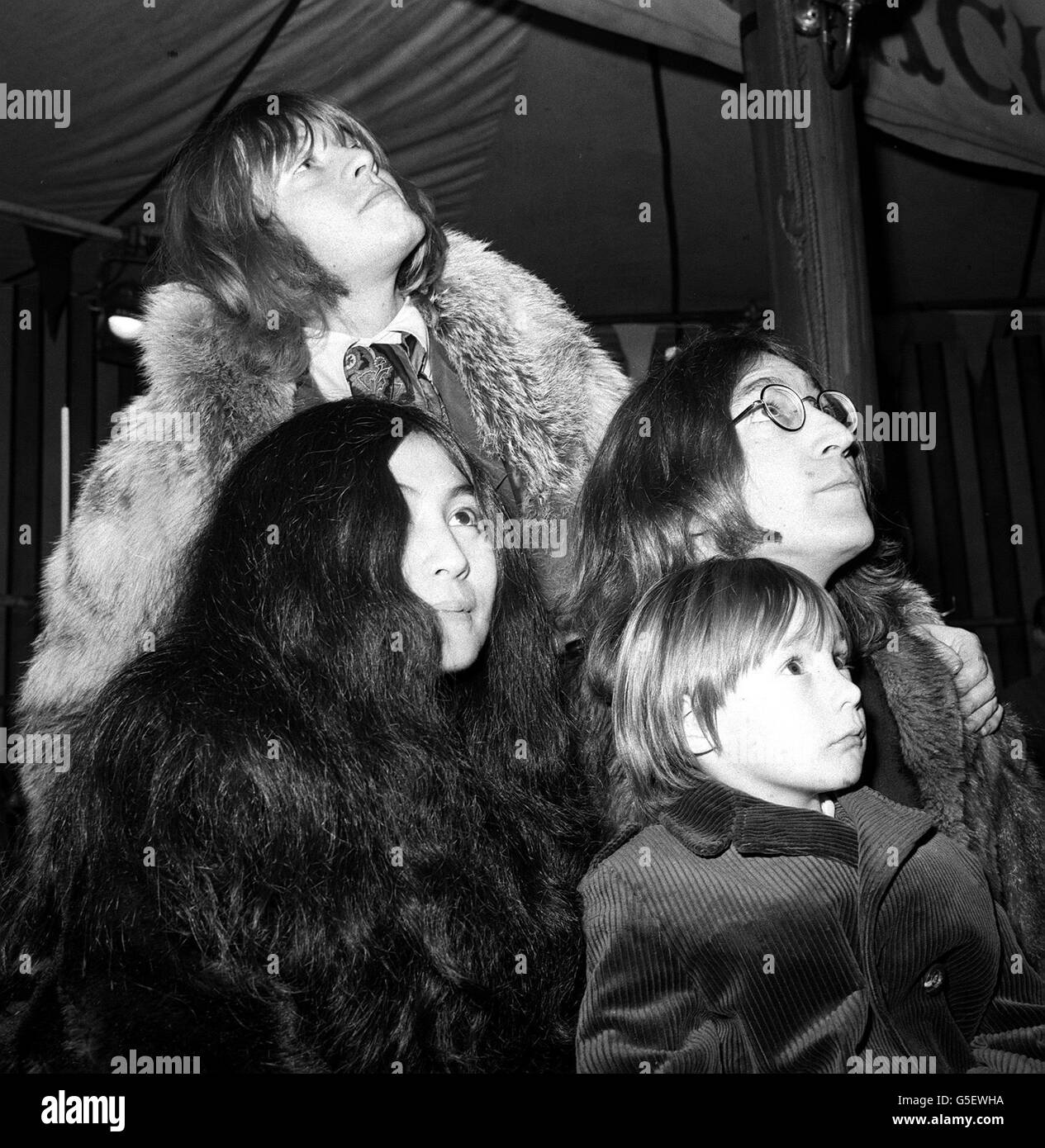 Julian Lennon (front) with his father John Lennon (right) of the Beatles, Japanese actress Yoko Ono (left) and Brian Jones of the Rolling Stones (back) at a rehearsp of the Rolling Stones' Rock and Roll Circus at the Intertel Studio, Wembley, London. CELEBRITY Stock Photo