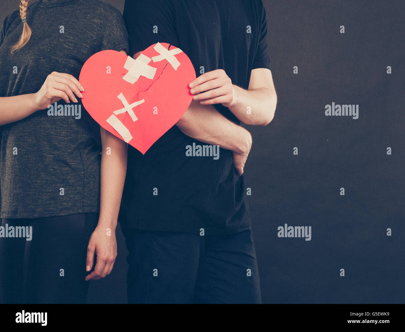 Broken heart difficult love concept. Couple woman and man hands holding ...