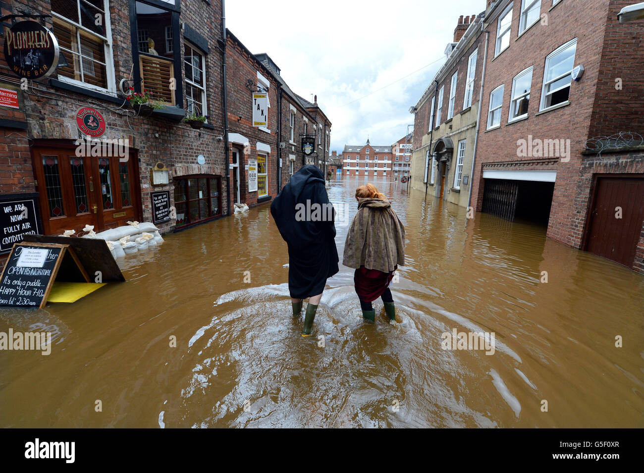 Floodwaters rise in city centre streets in York as the River Ouse continues to rise today following the torrential rainfalls of the past few days. Stock Photo