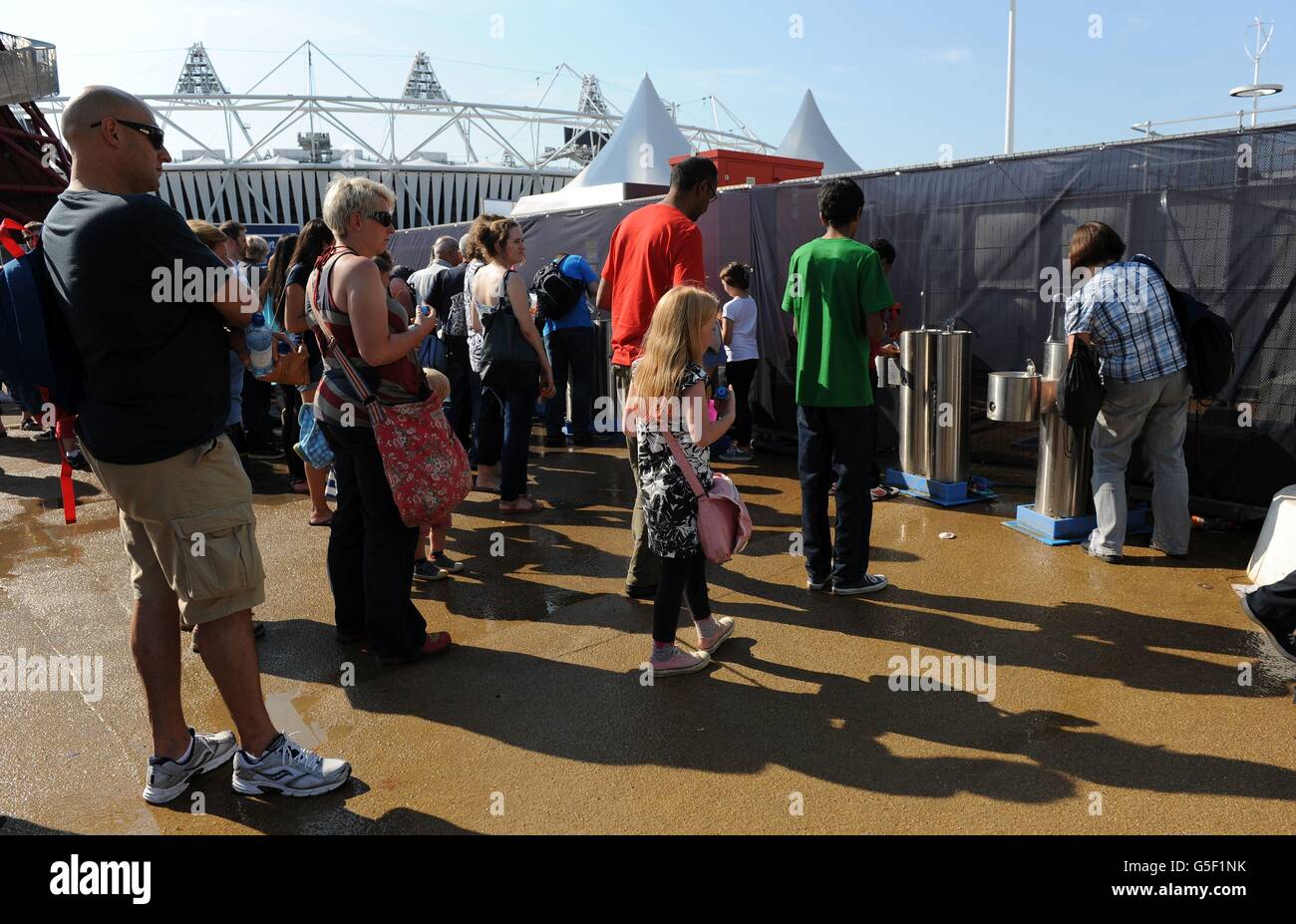 Fans queue to fill their water bottles inside the Olympic Park, London ...
