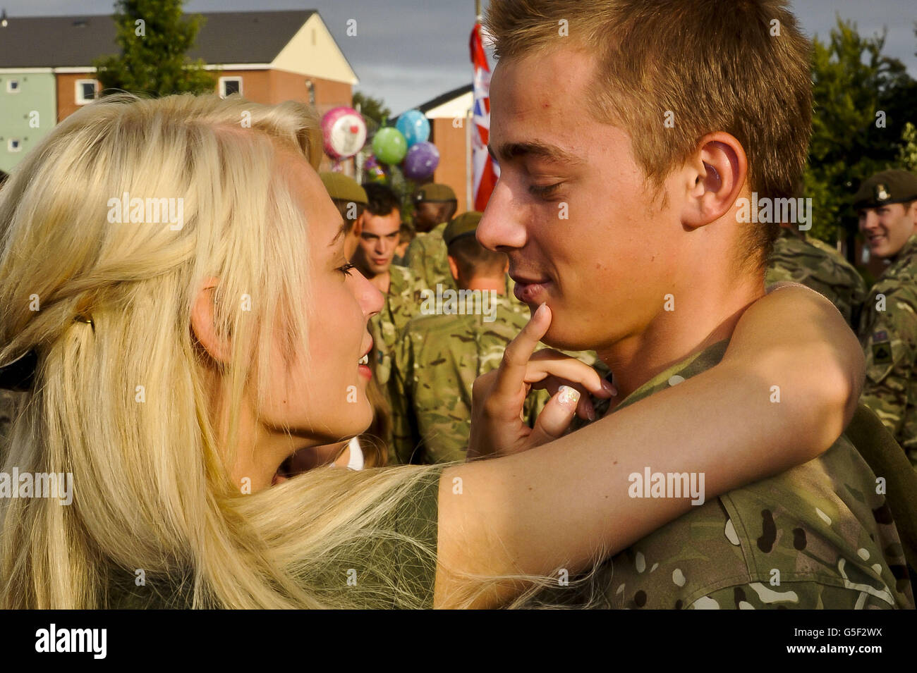 Private Sam Travis, 19, and his girlfriend Daniel Scholfield, 18, embrace as troops from Corunna Company, 3rd Battalion Yorkshire Regiment return from Afghanistan to Warminster in Wiltshire. Stock Photo