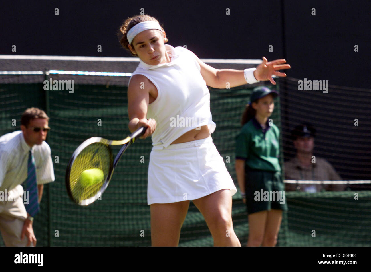 NO COMMERCIAL USE: Spain's Virginia Ruano Pascual returns the shot of Switzerland's Martina Hingis during the First Round match of the Lawn Tennis Championships at Wimbledon, London. Stock Photo