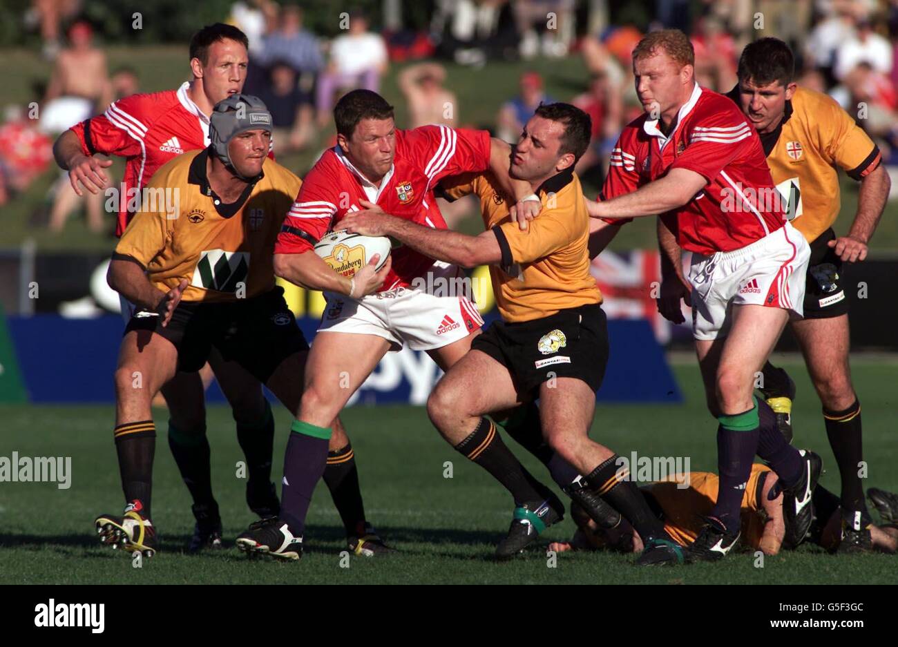 British and Irish Lions player Scott Gibbs (3rd left) attempts to break past NSW Country's Kieran Shepherd, during their rugby union tour match at Coffs Harbour, in Australia. Stock Photo