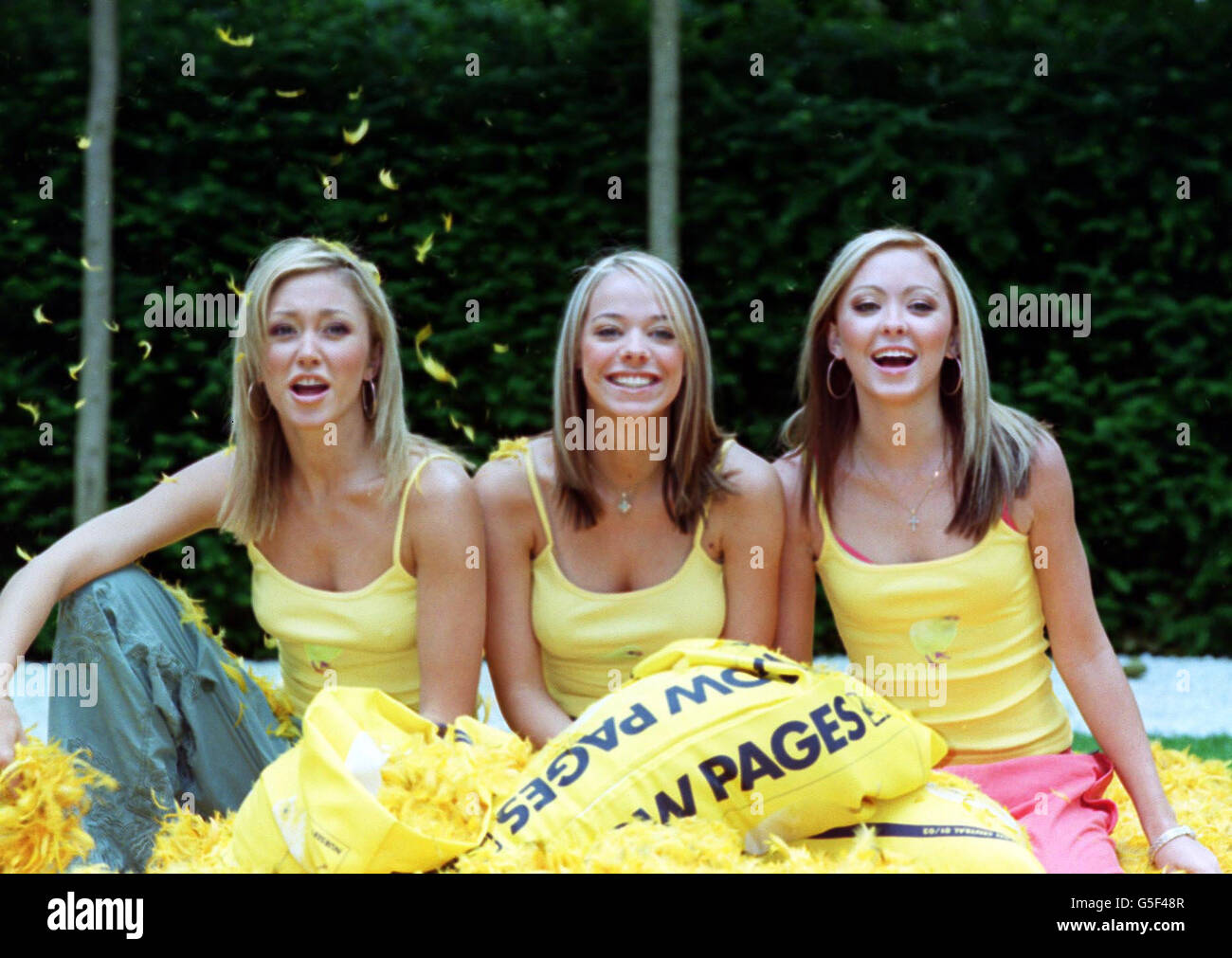 Pop group Atomic Kitten (from left) Jenny Frost, Liz Maclarnon and Natasha Hamilton, make feathers fly during a photocall in London to launch the new look chick-covered Yellow Pages Diretory. Stock Photo