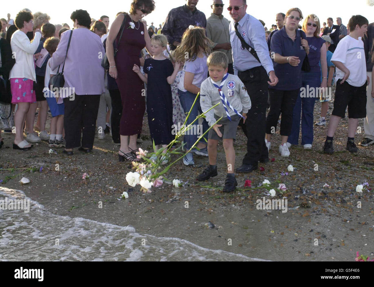 A young boy throws flowers into sea goring beach hires stock photography and images Alamy