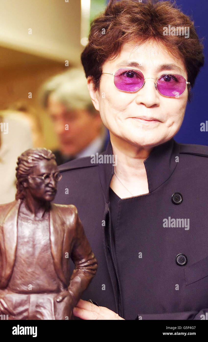 Yoko Ono, widow of singer John Lennon from the Beatles, visiting Liverpool Airport, which is to be named after her late husband when its new terminal opens to the public in Spring 2002. * The new logo for the airport includes the famous self-portrait by John Lennon and the strapline 'Above Us Only Sky' taken from the lyrics of Imagine. Yoko was presented with a miniture-sized statue. A full sized-version has been commissioned by local sculptor Tom Murphy and will be displayed in the airport's new terminal. Stock Photo