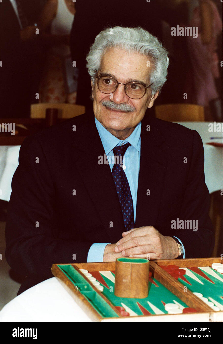 Actor Omar Sharif taking part in a backgammon tournament in aid of a children's charity. Omar Sharif hosted the event in St James Street, central London, to raise cash for the One to One Children's Fund. 7/8/03:Hollywood legend Omar Sharif has been given a one month suspended prison sentence, for head butting a policeman in a French casino. The 71-year-old Egyptian star of Doctor Zhivago and Lawrence of Arabia was also fined 1,000 for insults and violence directed at a policeman at the Enghien-les-Bains casino near Paris. Sharif was arguing with a croupier while playing roulette at the Stock Photo