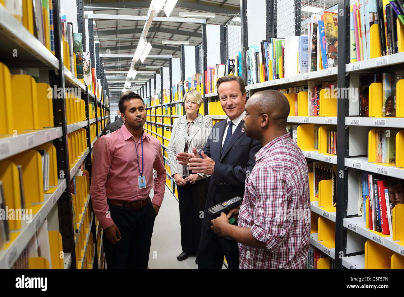 Prime Minister David Cameron talks to staff members Ashraf Choudhury