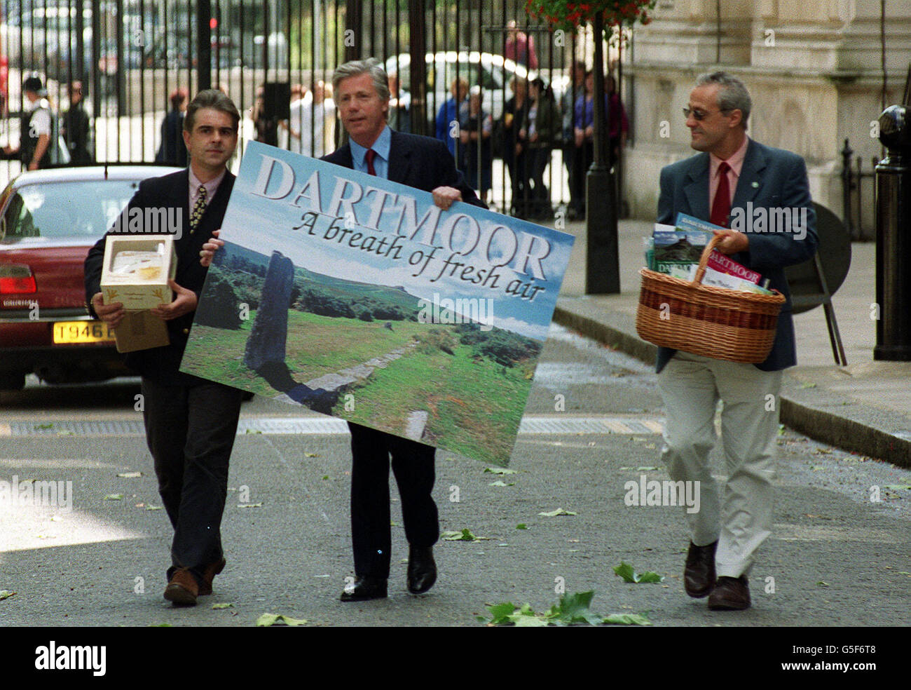 Devon MP John Burnett (C) carries a postcard to Prime Minister Tony Blair in Downing Street, accompanied by Adam Southwell (L), acting chairman of the Dartmoor Tourist Association and Jeff Haynes (Assistant National Park Officer - Park management). * They are highlighting that the Dartmoor National Park is due to reopen this coming weekend, and to encourage Mr Blair to visit the area this summer. Recent forecasts have estimated that in the aftermath of the foot and mouth crisis Devon may lose 357 million in tourism revenue and 11,000 jobs. Stock Photo